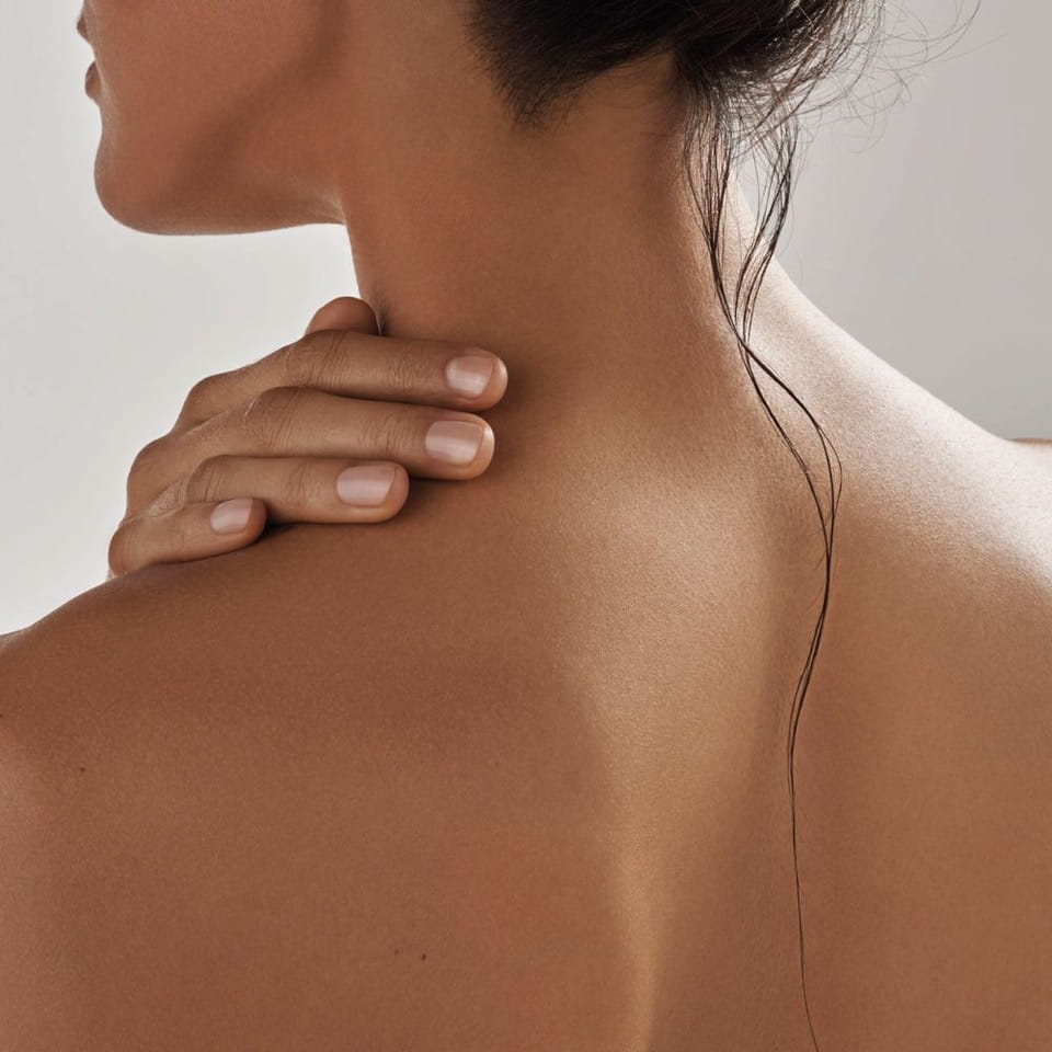 Woman resting a hand on her shoulder